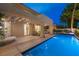 Inviting backyard pool at twilight, featuring a covered patio with lounge seating and ambient lighting, creating a tranquil ambiance at 5125 Turnberry Ln, Las Vegas, NV 89113