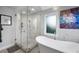 Luxurious bathroom with a glass shower enclosure and standalone tub, showcasing modern design at 5125 Turnberry Ln, Las Vegas, NV 89113