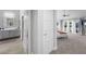 Hallway view to a primary bedroom with ensuite bath, ceiling fan, and outdoor access at 5125 Turnberry Ln, Las Vegas, NV 89113