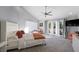 Sun-filled bedroom with vaulted ceiling, ceiling fan, patio access, and comfy lounge area at 5125 Turnberry Ln, Las Vegas, NV 89113