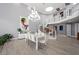 Dining room featuring a modern chandelier, curved staircase, and an open floor plan at 5125 Turnberry Ln, Las Vegas, NV 89113
