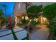 Inviting home exterior with manicured landscaping, outdoor seating, and walkway to front door at 5125 Turnberry Ln, Las Vegas, NV 89113