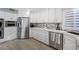 Bright kitchen showcasing stainless steel appliances, white cabinets, and stylish backsplash at 5125 Turnberry Ln, Las Vegas, NV 89113