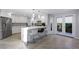 Bright kitchen boasts stainless steel appliances, white cabinets, and a breakfast bar at 5125 Turnberry Ln, Las Vegas, NV 89113