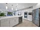 Modern kitchen featuring stainless steel appliances, a wine fridge, and a large island at 5125 Turnberry Ln, Las Vegas, NV 89113