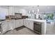 Modern kitchen featuring white cabinetry, stainless steel appliances, and a large island at 5125 Turnberry Ln, Las Vegas, NV 89113