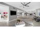 Open-concept living area with modern decor, wood floors, and seamless flow into the kitchen and dining spaces at 5125 Turnberry Ln, Las Vegas, NV 89113