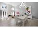 Bright living room with fireplace, high ceilings, modern chandelier, and open floor plan at 5125 Turnberry Ln, Las Vegas, NV 89113