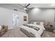 Spacious bedroom with a ceiling fan, modern decor, and a large comfortable bed at 5125 Turnberry Ln, Las Vegas, NV 89113