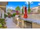 Built-in outdoor kitchen featuring a grill, countertop, and a stainless steel refrigerator at 5125 Turnberry Ln, Las Vegas, NV 89113