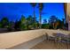 Evening view of the patio surrounded by lush landscaping and palm trees at 5125 Turnberry Ln, Las Vegas, NV 89113