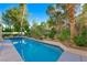 Sparkling swimming pool with manicured landscaping and a privacy fence, offering a serene outdoor escape at 5125 Turnberry Ln, Las Vegas, NV 89113