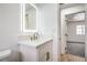 Modern bathroom featuring a sleek vanity with gold hardware, a mirror, and vinyl floors at 5239 Elgin Cir, Las Vegas, NV 89122