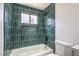 This bathroom features a soaking tub with stylish tile, a window, and modern fixtures at 5239 Elgin Cir, Las Vegas, NV 89122