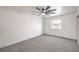 Spacious bedroom featuring neutral carpet, a ceiling fan, and a bright window at 5239 Elgin Cir, Las Vegas, NV 89122