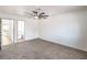 Relaxing bedroom offers plush gray carpet with two open doorways and a ceiling fan at 5239 Elgin Cir, Las Vegas, NV 89122