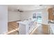 Bright kitchen boasts an island with seating and access to the outdoor pool through sliding glass doors at 5239 Elgin Cir, Las Vegas, NV 89122