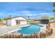 Inviting backyard features a refreshing pool with diving board and lush landscaping at 5239 Elgin Cir, Las Vegas, NV 89122