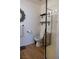 Bathroom with decorative mirror, wood-look flooring, floating shelves and glass-enclosed shower at 5400 Tassara Way # 106, Las Vegas, NV 89108
