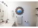 Bathroom boasts vanity with sink, toilet, decorative mirror and floating shelves at 5400 Tassara Way # 106, Las Vegas, NV 89108