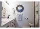 Bathroom features a double sink vanity, decorative mirror and updated fixtures at 5400 Tassara Way # 106, Las Vegas, NV 89108