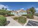 Charming villa with desert landscaping, red tile roof, and light colored siding at 5400 Tassara Way # 106, Las Vegas, NV 89108