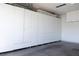 Spacious garage with built-in storage cabinets and a finished concrete floor at 5400 Tassara Way # 106, Las Vegas, NV 89108