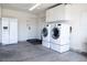 Functional garage interior with washer, dryer, refrigerator, and overhead storage at 5400 Tassara Way # 106, Las Vegas, NV 89108