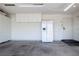 Organized garage featuring built-in cabinets, refrigerator, and finished floor at 5400 Tassara Way # 106, Las Vegas, NV 89108