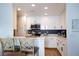 Bright and modern kitchen with white cabinets, stainless steel appliances, and bar seating at 5400 Tassara Way # 106, Las Vegas, NV 89108
