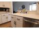 Bright kitchen with modern stainless steel dishwasher, white cabinets and countertops at 5400 Tassara Way # 106, Las Vegas, NV 89108