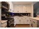 Well-lit kitchen with stainless steel appliances, white cabinets, and wood flooring at 5400 Tassara Way # 106, Las Vegas, NV 89108
