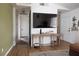 Spacious living room featuring a console table, large TV, and wood-look flooring at 5400 Tassara Way # 106, Las Vegas, NV 89108