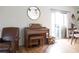 Warm living room with a piano, a chair, and sliding glass doors to the patio at 5400 Tassara Way # 106, Las Vegas, NV 89108