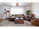 Inviting living room with stylish decor, large window, plush seating, and hardwood floors at 5400 Tassara Way # 106, Las Vegas, NV 89108