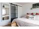 Comfortable bedroom with decorative sliding glass door, pillows and decor at 5400 Tassara Way # 106, Las Vegas, NV 89108