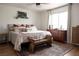 Comfortable bedroom with large window, wood floors, accent rug, and dresser at 5400 Tassara Way # 106, Las Vegas, NV 89108