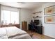 Comfortable bedroom with large window, wood floors, desk and chair at 5400 Tassara Way # 106, Las Vegas, NV 89108