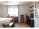 Comfortable bedroom with large window, wood floors, desk and chair at 5400 Tassara Way # 106, Las Vegas, NV 89108