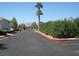Wide street with palm trees and manicured landscaping at 5400 Tassara Way # 106, Las Vegas, NV 89108