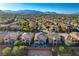 Real estate aerial view showcasing houses, roofs, trees, and lush landscaping in a suburban neighborhood at 5434 Fawn Chase Way, Las Vegas, NV 89135
