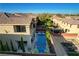 Aerial view of a home's backyard featuring a pool, patio, and outdoor seating area at 5434 Fawn Chase Way, Las Vegas, NV 89135