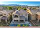 The home offers a large swimming pool and covered patio with scenic mountain views at 5434 Fawn Chase Way, Las Vegas, NV 89135