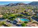 Community aerial view highlighting the pool and surrounding homes with mountain views at 5434 Fawn Chase Way, Las Vegas, NV 89135