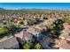 Expansive aerial view of the neighborhood with houses, roads, trees, and mountains in the background at 5434 Fawn Chase Way, Las Vegas, NV 89135