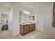 Bathroom with double vanity, light fixtures, tile flooring, and white doors at 5434 Fawn Chase Way, Las Vegas, NV 89135