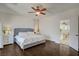 Bright bedroom featuring wood floors, ceiling fan, and a comfy bed with white linens at 5434 Fawn Chase Way, Las Vegas, NV 89135