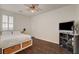 Cozy bedroom with dark wood floors, window with shutters, and ceiling fan at 5434 Fawn Chase Way, Las Vegas, NV 89135