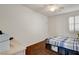 Comfortable bedroom featuring dark wood floors, a ceiling fan, and closet at 5434 Fawn Chase Way, Las Vegas, NV 89135