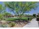Park area with walking path, open green space, play equipment, and shady trees at 5434 Fawn Chase Way, Las Vegas, NV 89135